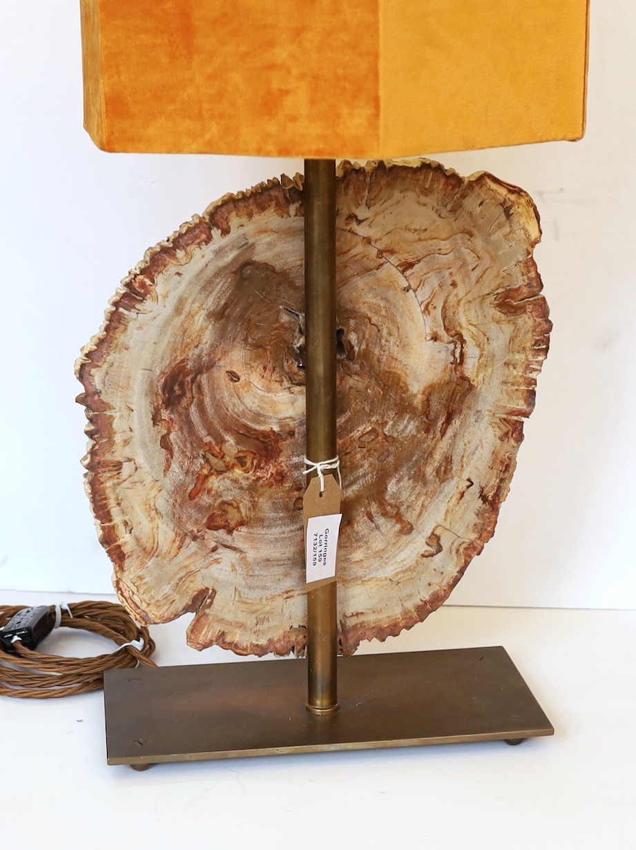 A bronze and petrified wood table lamp, height 60cm. width 28cm